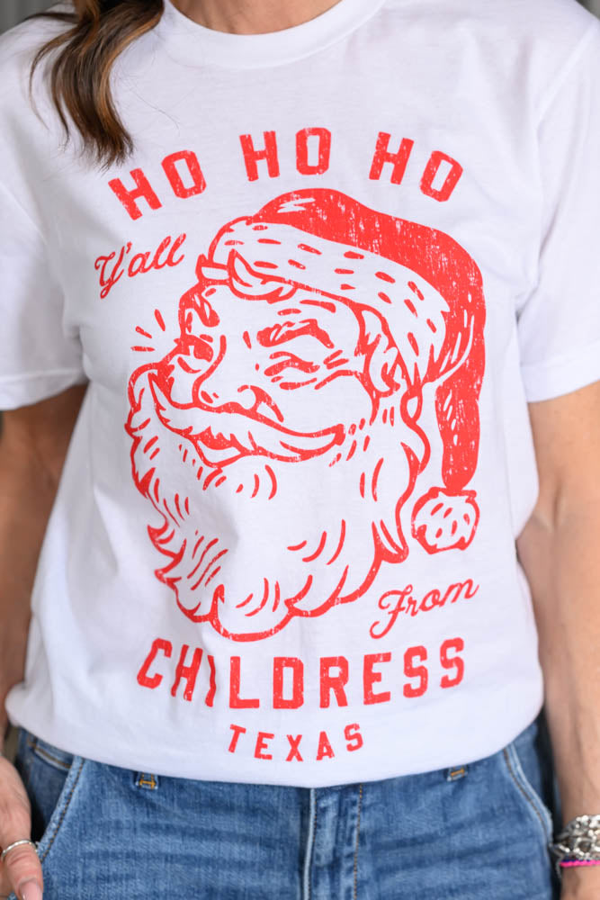 Jennifer Smith of STS Ranch and 1930 Remnant modeling a Christmas graphic tee shirt that reads, "Ho Ho Ho Y'all from Childress, Texas." close up shot
