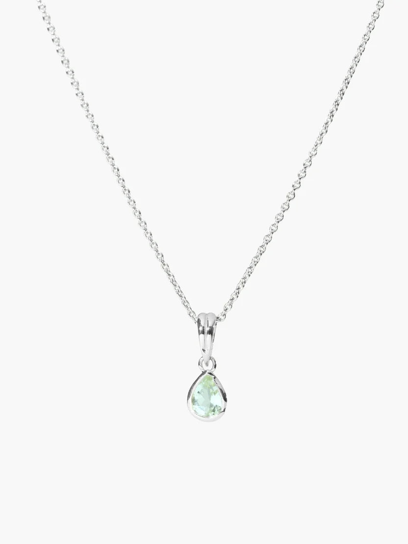 A silver chain necklace with a teardrop-shaped pendant featuring a light green gemstone, set against a plain light gray background.