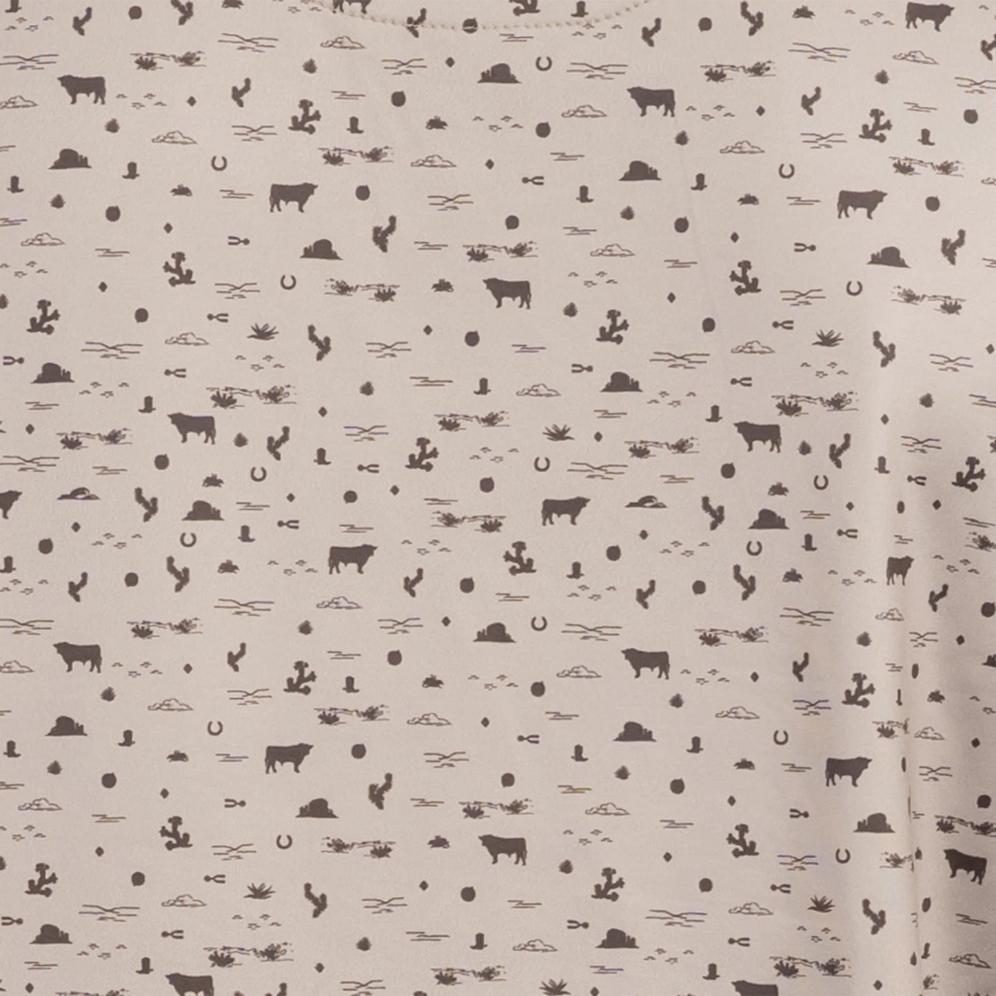 Close-up of desert sand shirt with chocolate western pattern detail