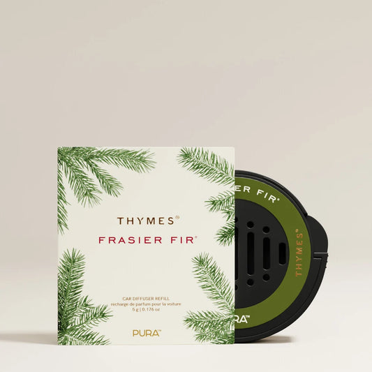 Pura Thymes Frasier Fir car diffuser refill, showing the white and green illustrated outer box next to the black and olive green circular diffuser cartridge on a light beige background.