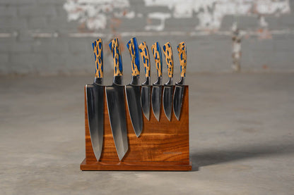 STS Kitchen knives Cholla cactus with blue inlay on wooden block with blurred industrial background