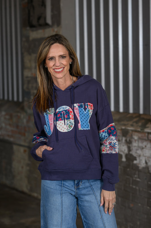 Jennifer Smith of STS RAnch & 1930 Remnant modeling the "Joy" quilted sweatshirt front view
