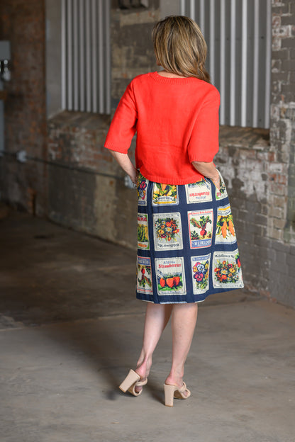 Back view of Ivy Jane coral cardigan sweater with elbow-length sleeves and relaxed cropped fit
