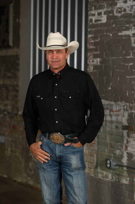Stran Smith of sTS Ranch wearing a black GameGuard Stockyard Shirt with snap front, dual flap pockets and long sleeves
