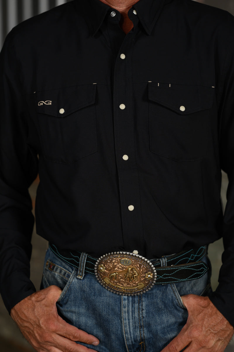 Close-up of black GameGuard Stockyard Shirt showing snap buttons, two flap chest pockets and embroidered logo