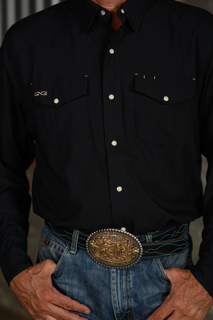 Close-up of black GameGuard Stockyard Shirt showing snap buttons, two flap chest pockets and embroidered logo