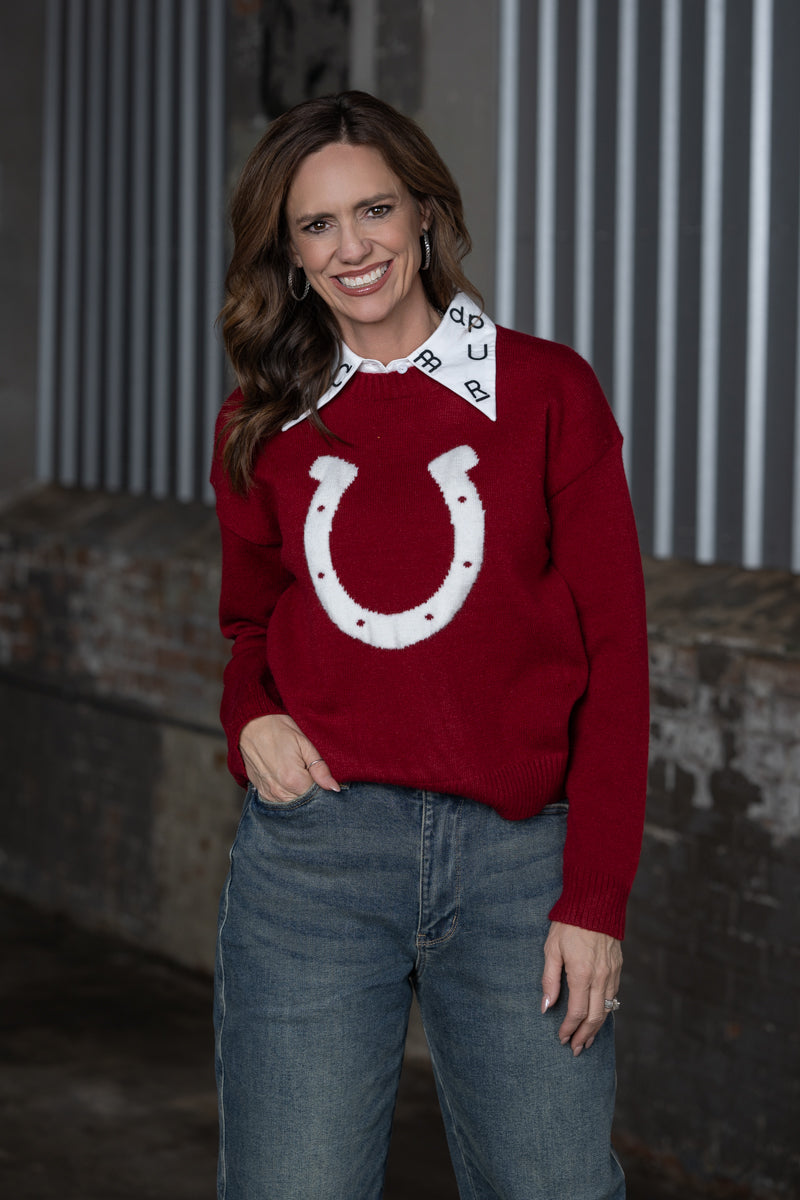 Jennifer Smtih of STS Ranch/1930 Remnant modeling a maroon sweater with a horseshoe detail on front with a brand collar at the top