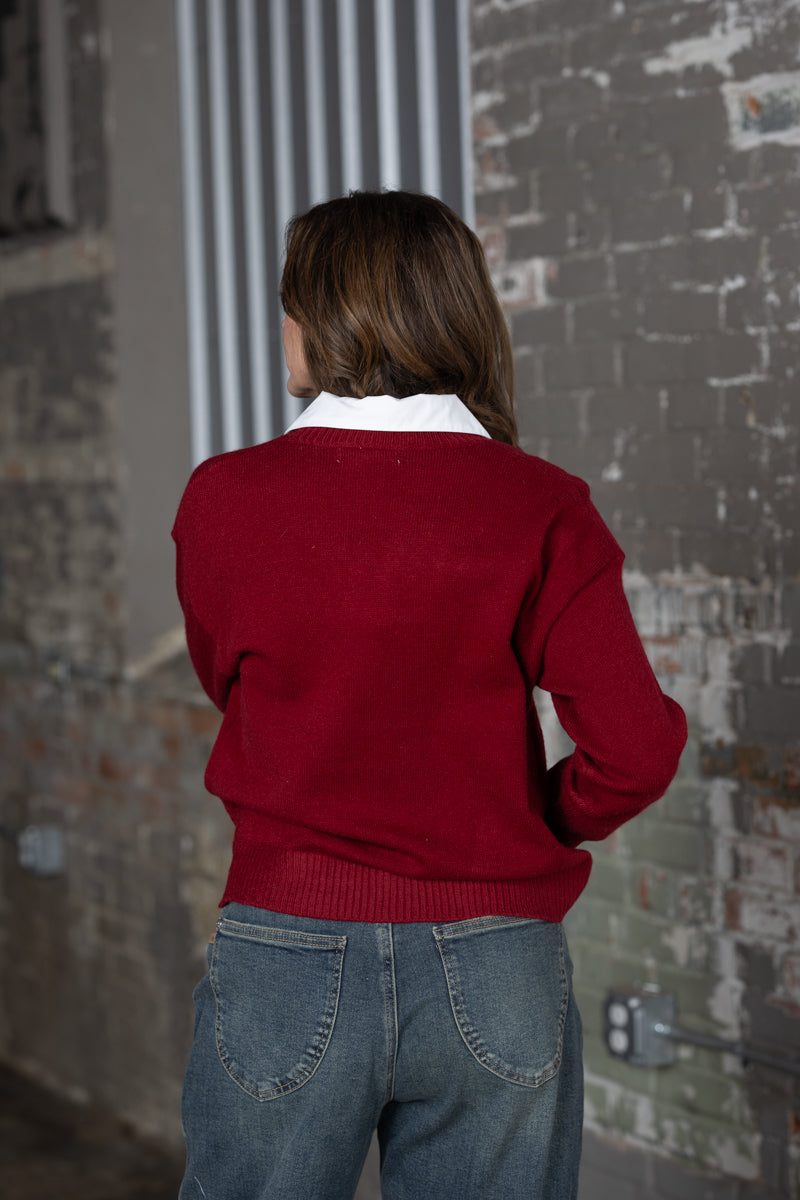 Back view Jennifer Smtih of STS Ranch/1930 Remnant modeling a maroon sweater with a horseshoe deatail on front