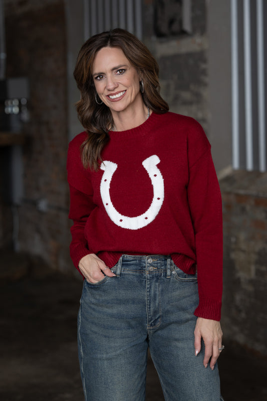 Jennifer Smtih of STS Ranch/1930 Remnant modeling a maroon sweater with a horseshoe deatail on front