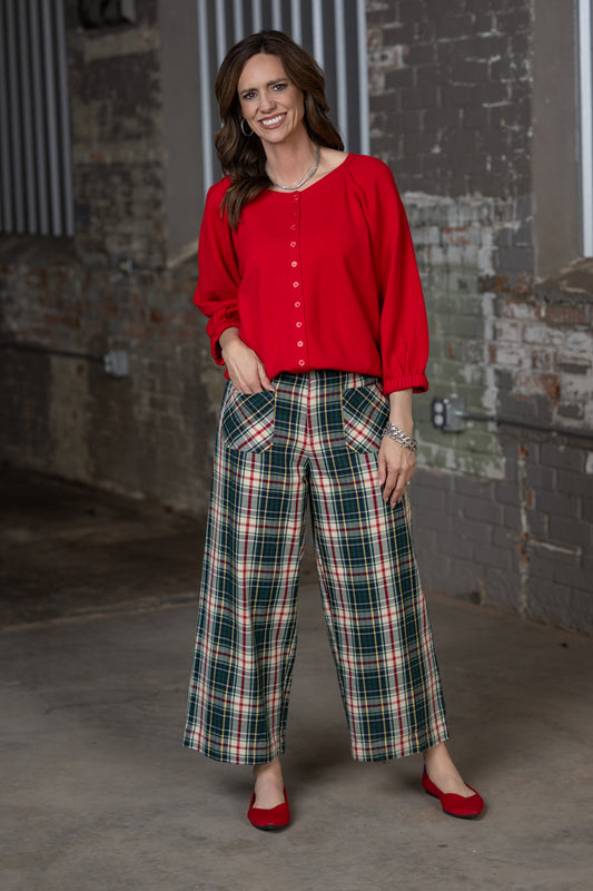 Jennifer Smith of STS Ranch and 1930 Remnant modeling a red cardigan sweater paired with Tartan plaid pants by Ivy Jane