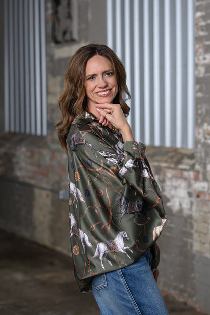 Side view of Jennifer Smith STS Ranch 1930 Remnant modeling the Beulah Style horse print top in olive green