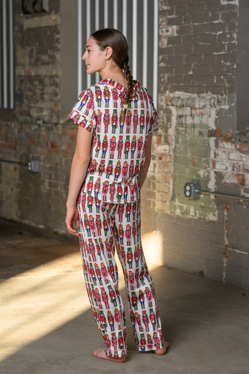 Model wearing the Simply Southern Holiday Lily Nutcracker Pajama Set with a henley top and wide-leg drawstring pants