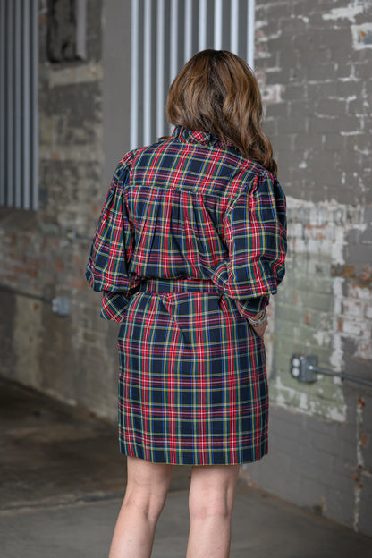 back view of Jennifer Smith of STS Ranch/1930 Remnant wearing a tartan black shirt dress by Ivy Jane in a warehouse