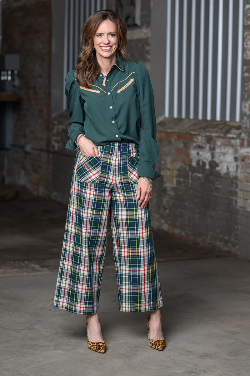 Full length view of Jennifer Smith of STS Ranch/1930 Remnant modeling the Howdy Hanny Green & Tan long sleeve shirt and Ivy Jain tartan plaid pants