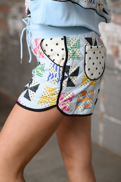 close up of side of Poppy & Pine Quilted Kaleidoscope shorts on a model with matching shorts