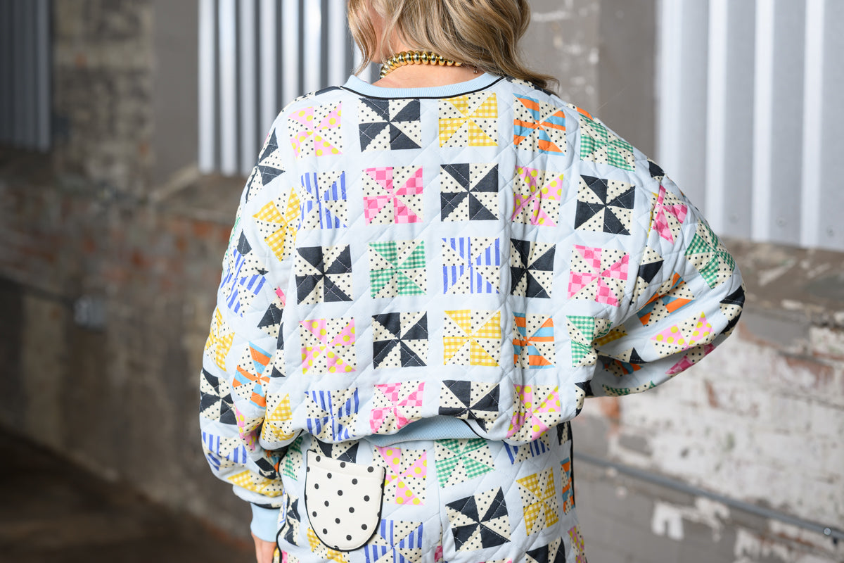 close up back view of Poppy & Pine Quilted Kaleidoscope Sweatshirt on a model with matching shorts
