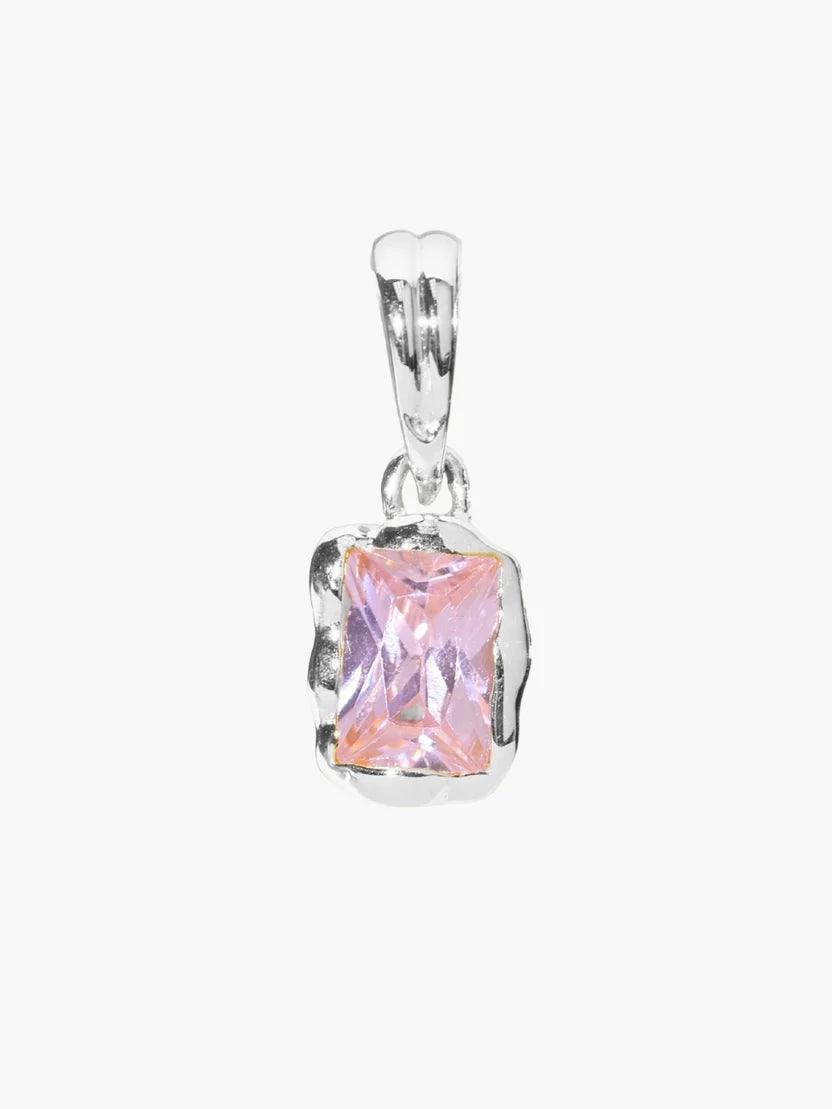 Silver pendant with a pink gemstone on a white background