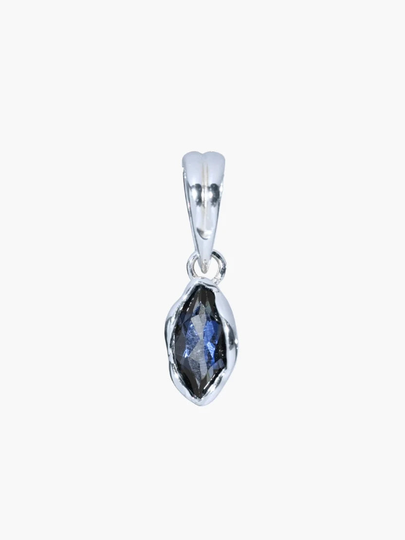 A silver pendant featuring a marquise-cut dark blue gemstone in a textured bezel setting, shown against a plain light gray background.