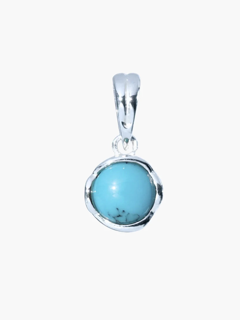 Turquoise stone pendant in silver setting on a white background