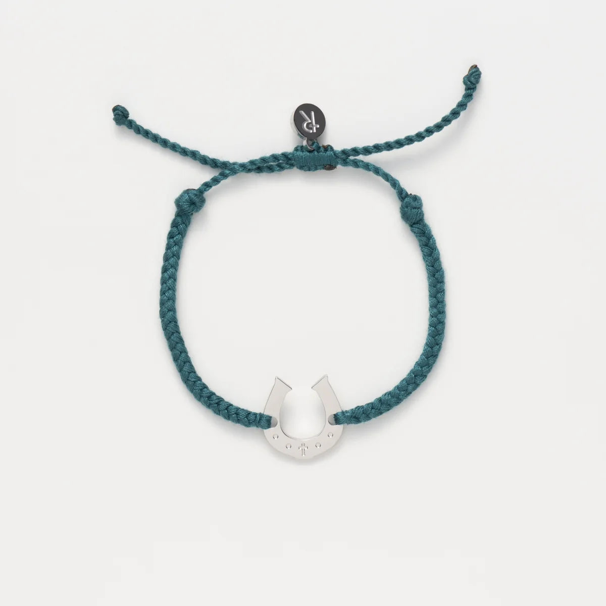 Teal braided bracelet with a silver U-shaped charm on a white background