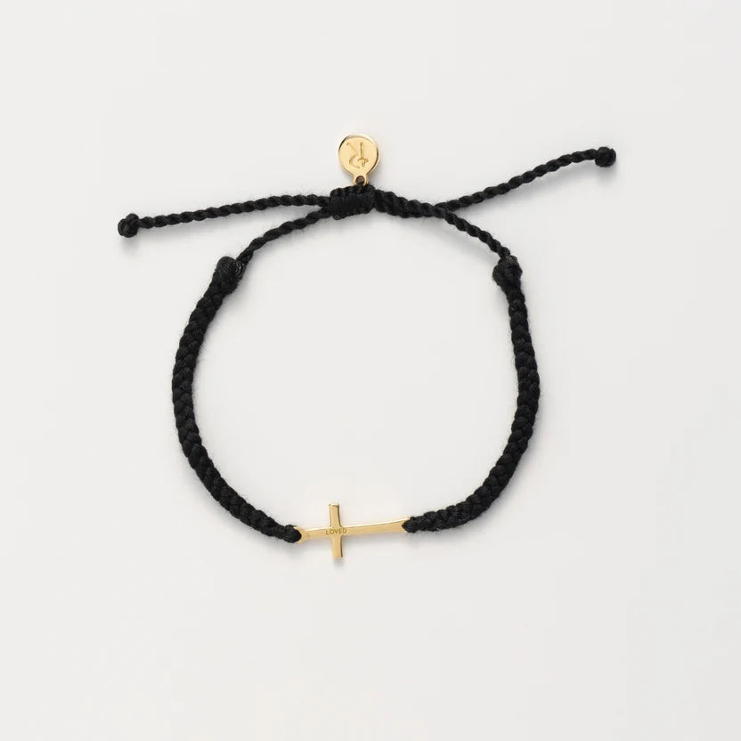 Black braided bracelet with gold anchor charm on a white background