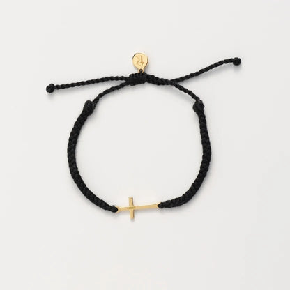 Black braided bracelet with gold anchor charm on a white background