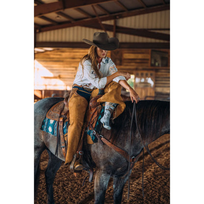 A Woman on a horse wearing Lucky Chuck Cosmic Cowgirl performance boot socks in light blue