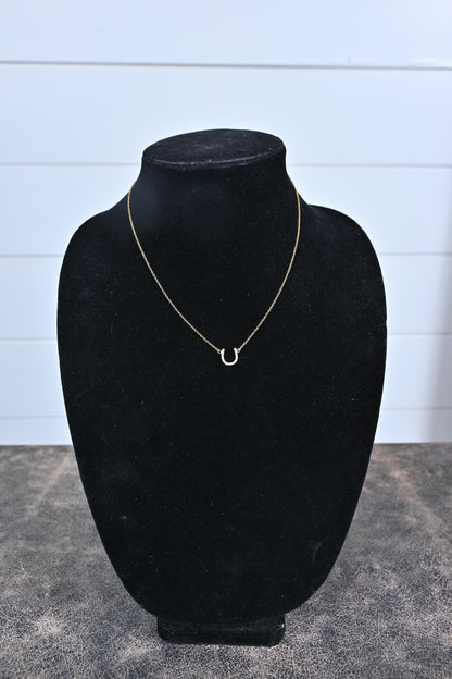 delicate horseshoe necklace in gold on black display