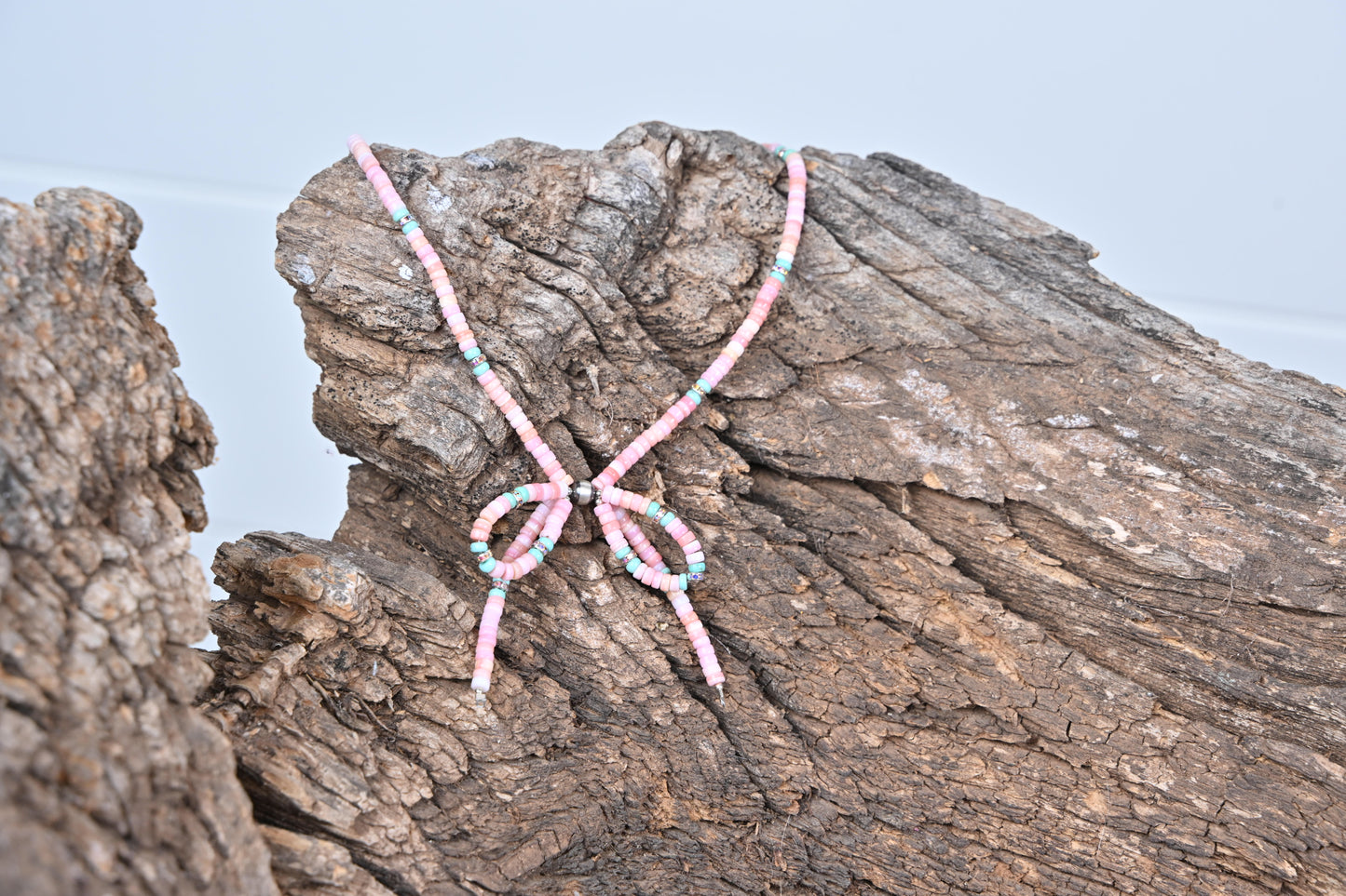 Western style beaded bow necklace with pink conch and rhinestones