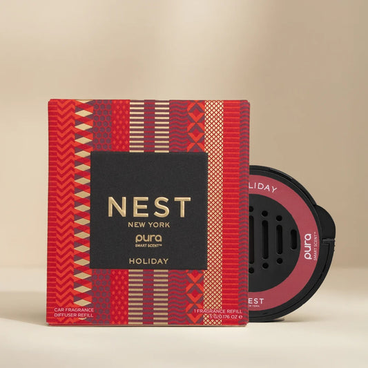 NEST New York holiday fragrance packaging with red and gold design on a beige background