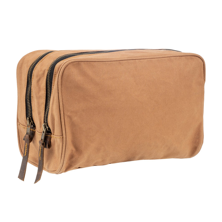 A rectangular tan canvas toiletry bag with two black zippers and leather zipper pulls, shown on a plain white background.