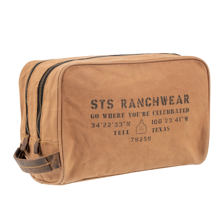 Brown toiletry bag with 'STS Ranchwear' branding and coordinates on a white background