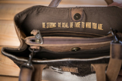 quote "Be Strong, Be Real, Be True to Who You Are." inside STS Ranchwear Cowhide Josie Satchel Jennifer Smith STS Ranch