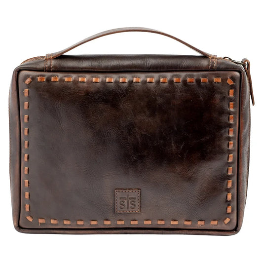 A dark brown leather travel or prayer bag with a top handle, decorative contrast stitching, and a small embossed logo patch on the front, shown against a plain white background.