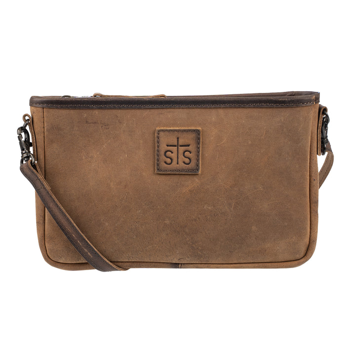 A brown distressed leather crossbody bag with a front zippered pocket and a central square patch featuring a cross and the letters 's s'.