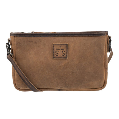 A brown distressed leather crossbody bag with a front zippered pocket and a central square patch featuring a cross and the letters 's s'.