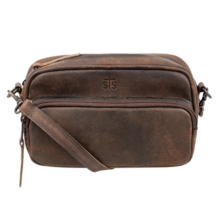 A dark brown distressed leather crossbody bag with a front zippered pocket, embossed 'STS' logo, and a matching leather strap, shown on a plain white background.