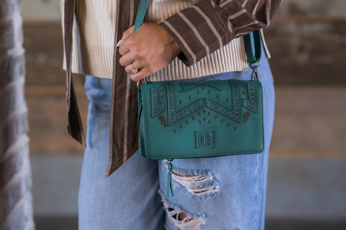 STS Ranchwear Wayfarer Turquoise Evie Organizer open showing card slots, ID window and two zip pouches designed by Jennifer Smith STS Ranch close up on model