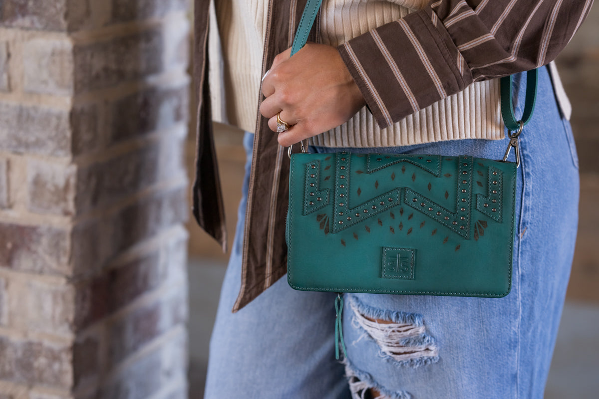 Close up of the STS Ranchwear Wayfarer Turquoise Evie Organizer crossbody with western cutout and stud details designed by Jennifer Smith STS Ranch