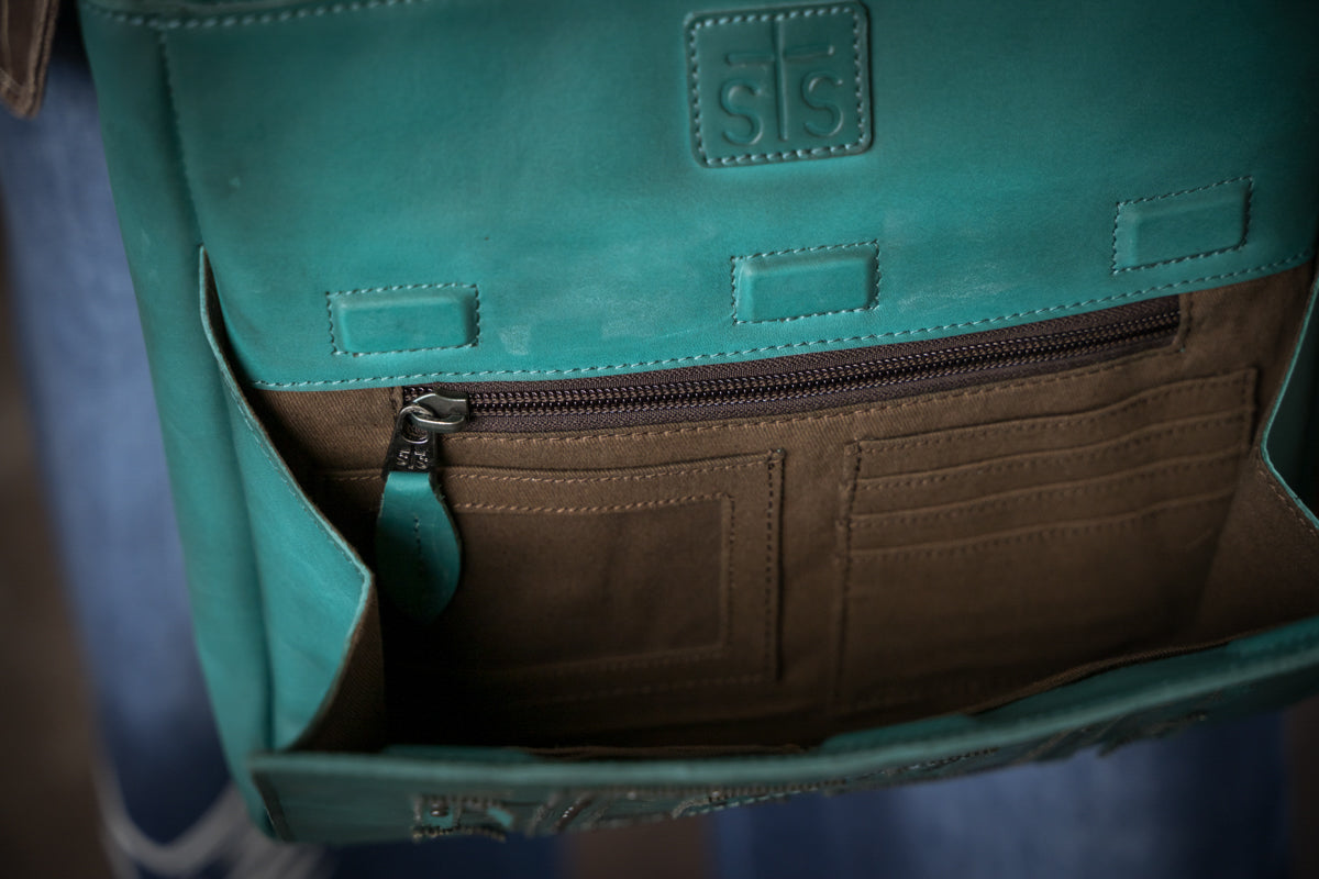 Interior view of turquoise crossbody with card slots and zipper pocket