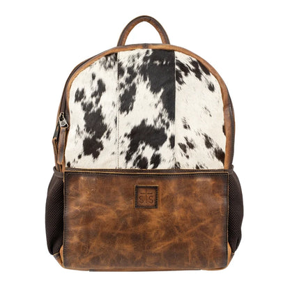 A backpack featuring a black and white cowhide pattern on the upper section and a distressed brown leather lower section, with dark brown mesh side pockets and a top handle, shown against a plain white background.