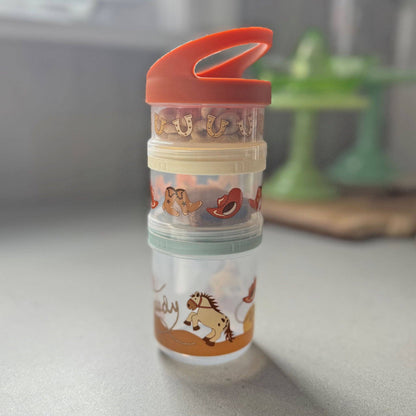A set of three stacked snack containers with a boots and Howdy motif, in orange, green, and clear colors, with animal illustrations.