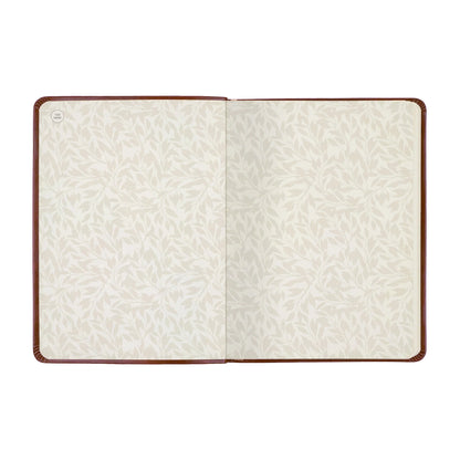 An open notebook or journal with cream-colored patterned pages and a dark brown leather cover, shown flat against a white background.