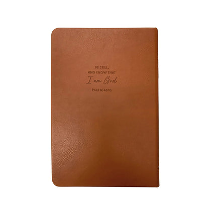 Brown leather notebook with engraved text on a white background