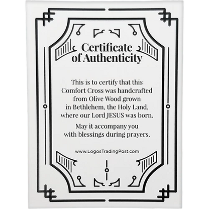 A white rectangular card with black decorative border lines and the centered text 'Certificate of Authenticity' followed by a handcrafted olive wood comfort cross message and the website www.LogosTradingPost.